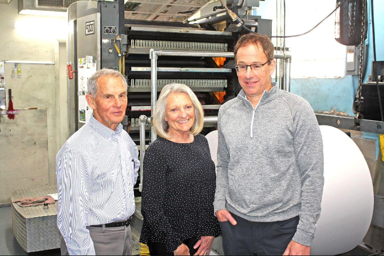 From left, Merle and Mary Baranczyk, Arkansas Valley Publishing Co., and Jim O’Rourke, O’Rourke Media Group, inspect the presses at The Mountain Mail. Photo by Brian McCabe